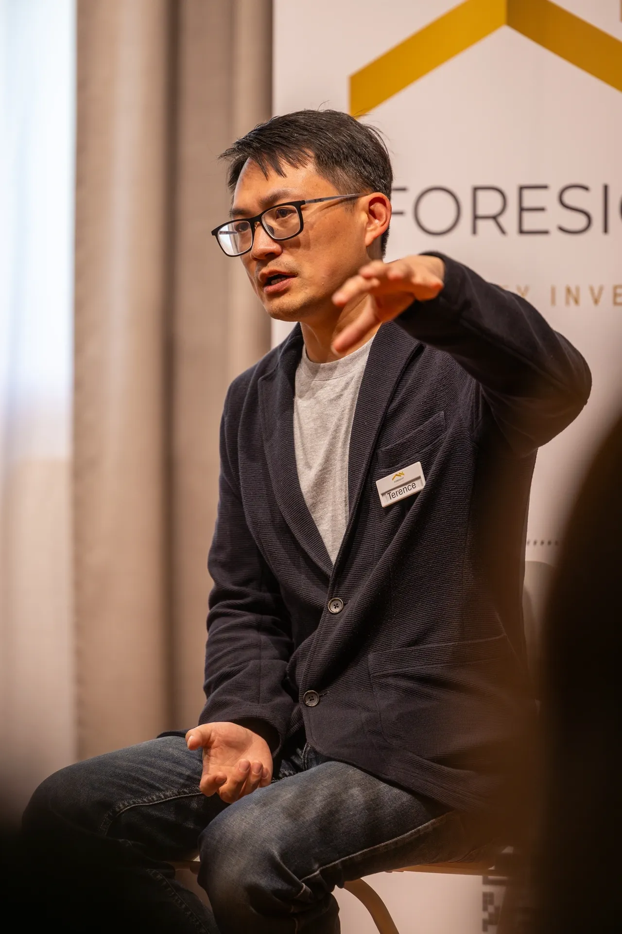 Man speaking passionately at a conference or seminar.
