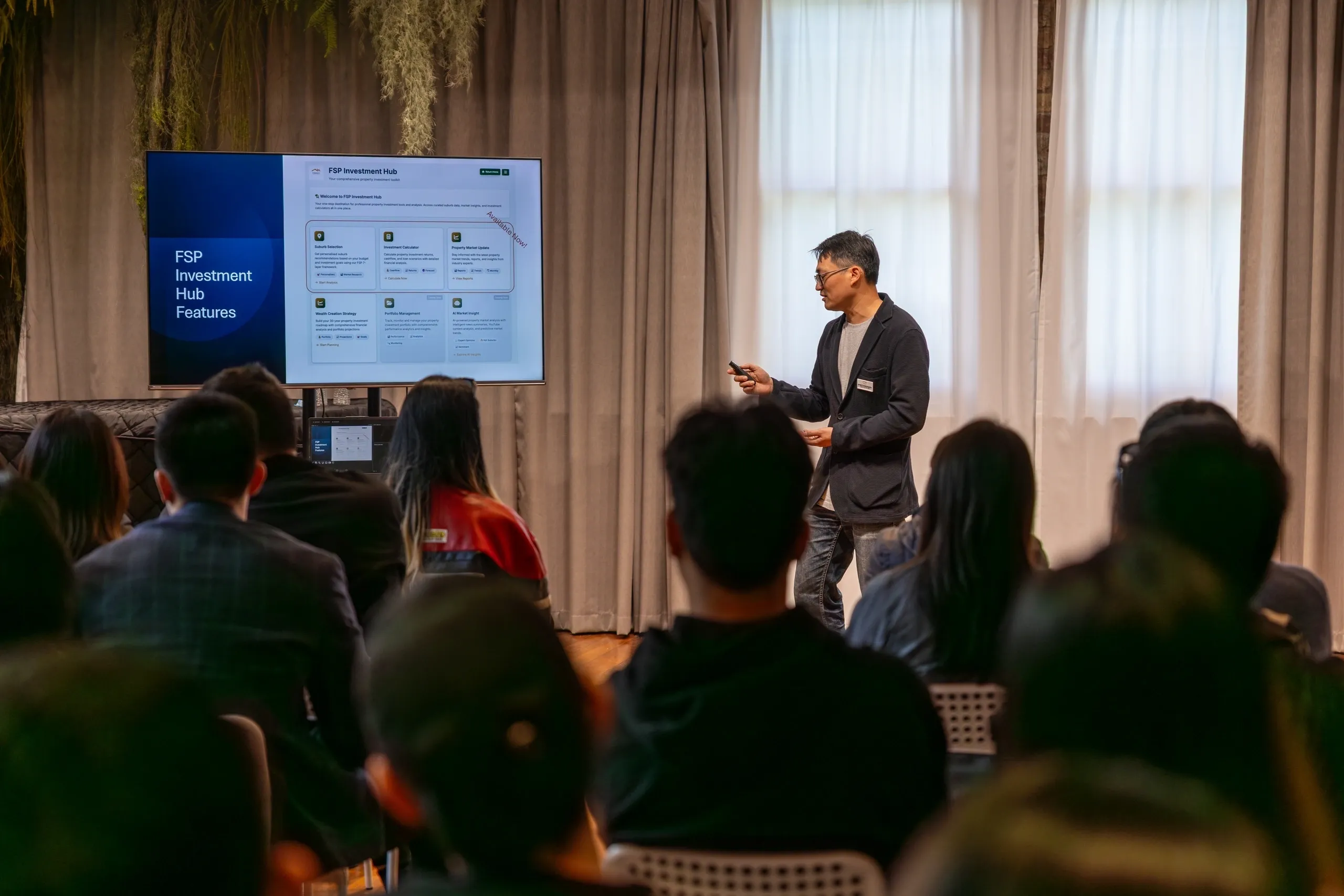 A man giving a presentation to an audience using a large screen.