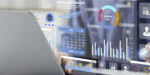 A person analyzing data and charts on a transparent digital interface above a laptop.